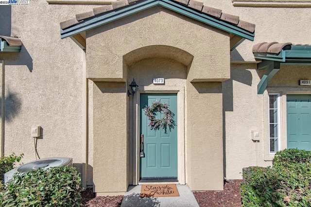 doorway to property with central air condition unit