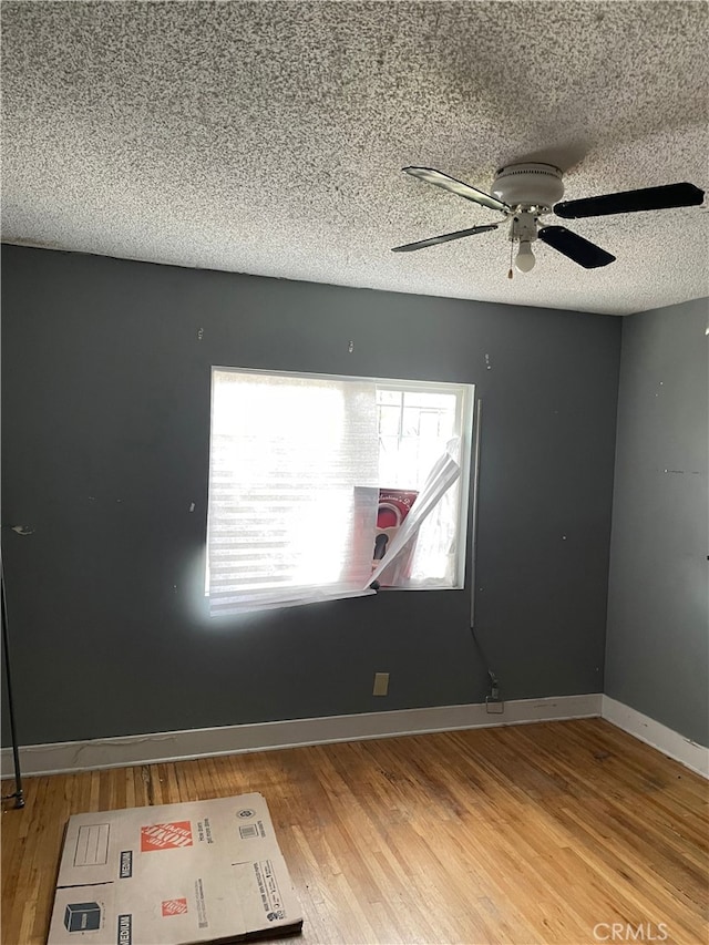 unfurnished room with hardwood / wood-style floors, a textured ceiling, and ceiling fan