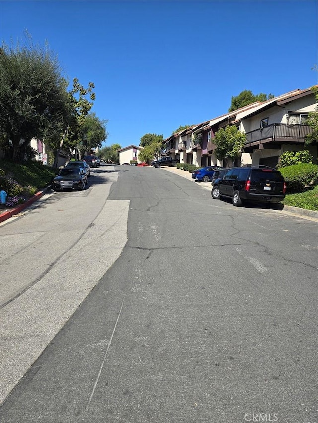 view of road featuring curbs and a residential view