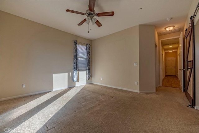 empty room with light colored carpet and ceiling fan