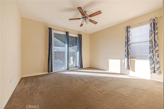 spare room featuring ceiling fan and carpet floors