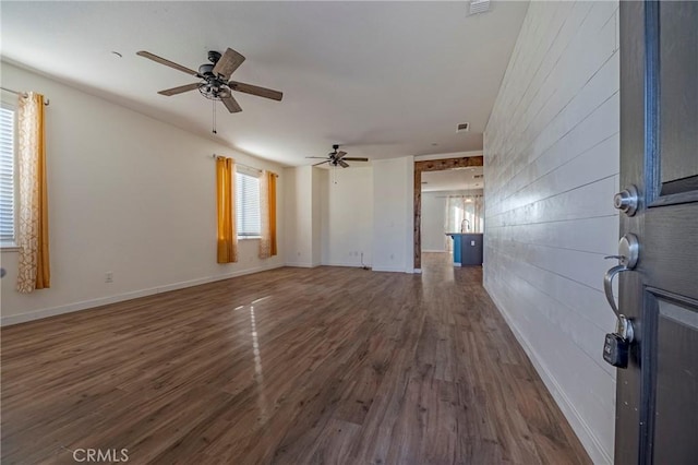 unfurnished room with ceiling fan and dark hardwood / wood-style floors