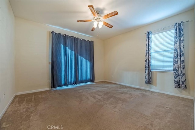 unfurnished room featuring ceiling fan and carpet flooring