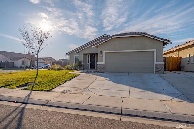 ranch-style house featuring a garage and a front lawn