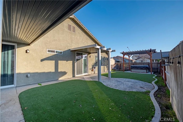 rear view of property featuring a pergola, a lawn, and a patio