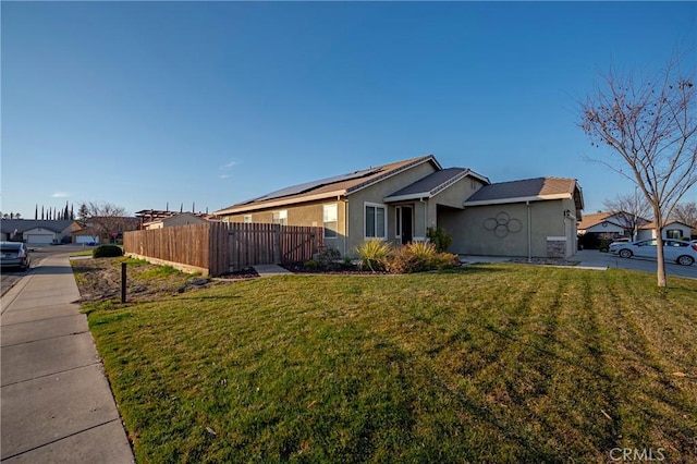 view of property exterior with a yard and solar panels