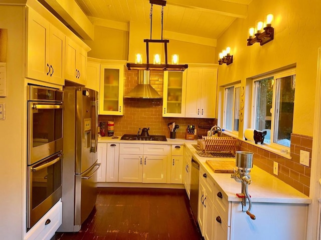 kitchen featuring vaulted ceiling with beams, a chandelier, hanging light fixtures, appliances with stainless steel finishes, and white cabinets