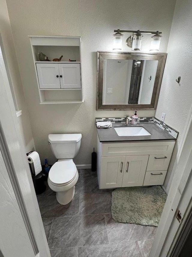 bathroom featuring vanity and toilet