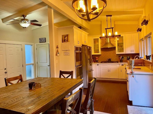 kitchen featuring white cabinetry, tasteful backsplash, lofted ceiling with beams, pendant lighting, and stainless steel appliances