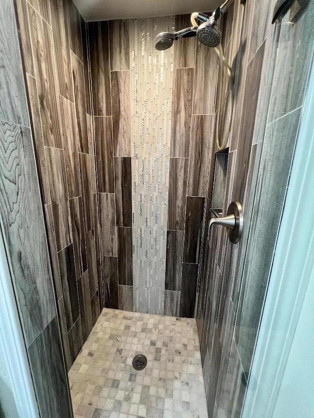 bathroom with a tile shower