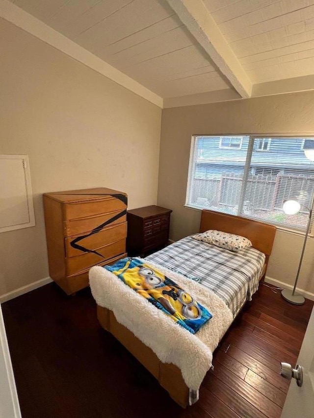 bedroom featuring dark wood-type flooring and beamed ceiling