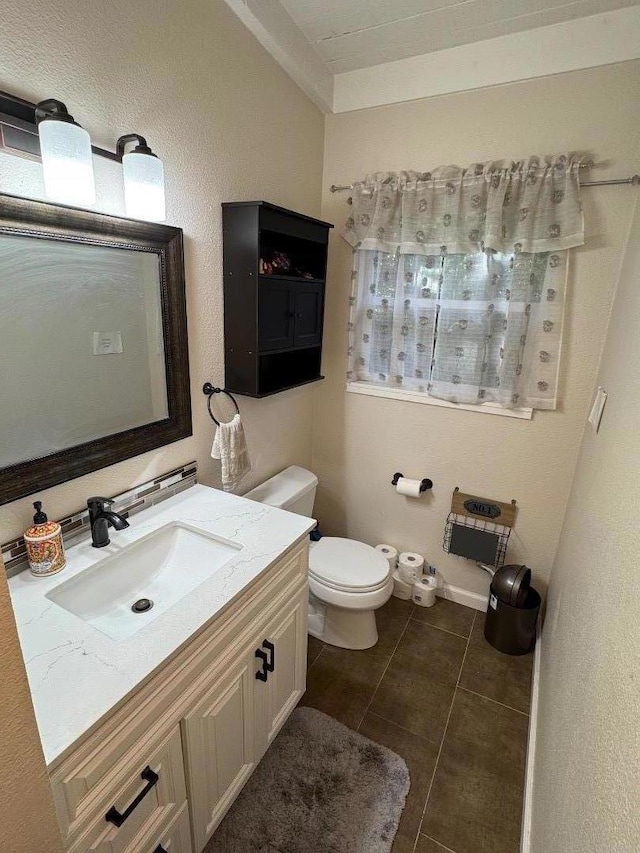 bathroom with vanity, tile patterned floors, and toilet