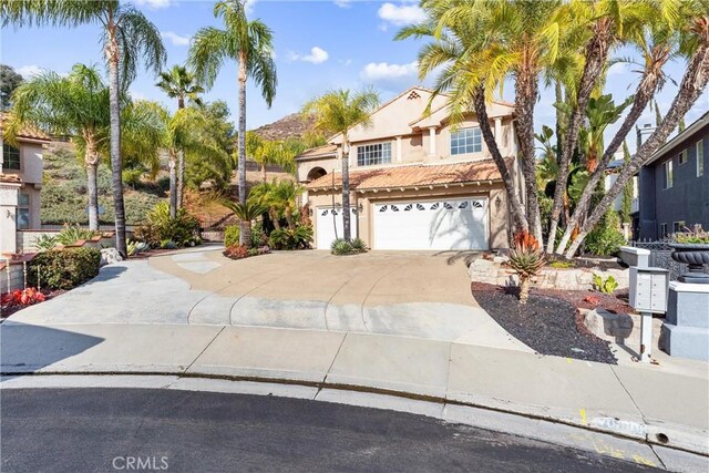 mediterranean / spanish-style home with a garage