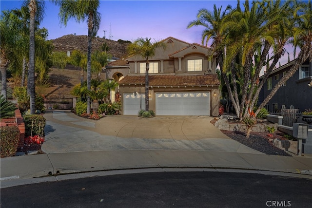 mediterranean / spanish-style home featuring a garage and a mountain view