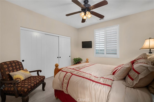 bedroom featuring ceiling fan, a closet, and carpet