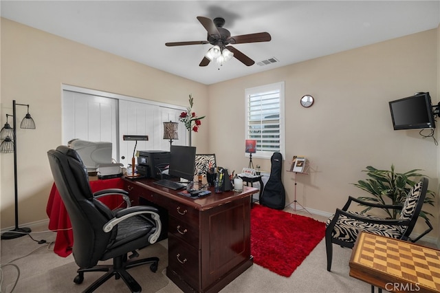 carpeted home office with ceiling fan