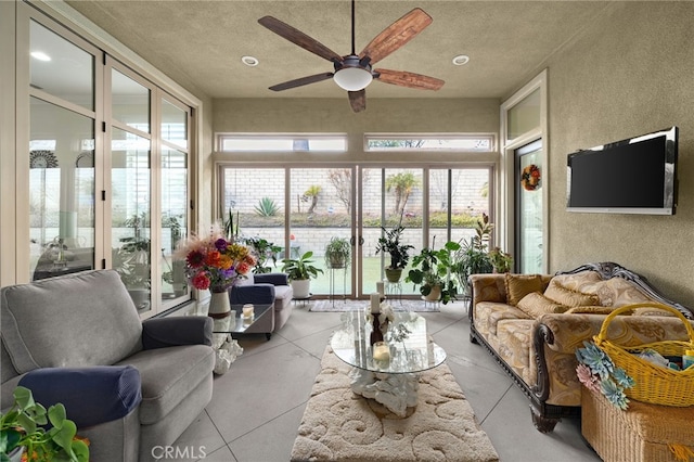 sunroom / solarium featuring ceiling fan