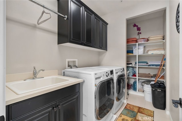 laundry area featuring independent washer and dryer, cabinets, sink, and light tile patterned floors