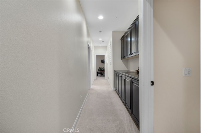 hall featuring light colored carpet