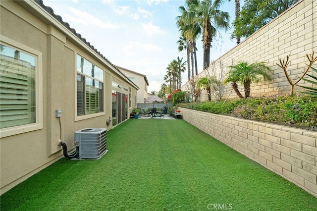 view of yard featuring a patio and central air condition unit