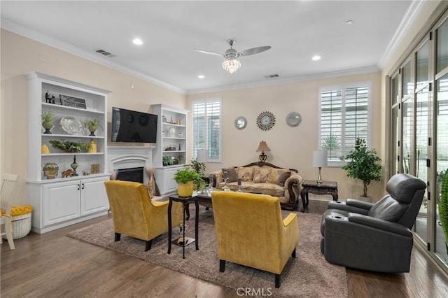 living room featuring ornamental molding, dark wood-type flooring, and ceiling fan