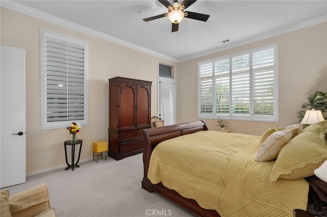 carpeted bedroom with crown molding and ceiling fan