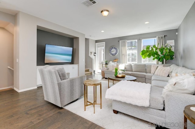 living room featuring dark wood-type flooring