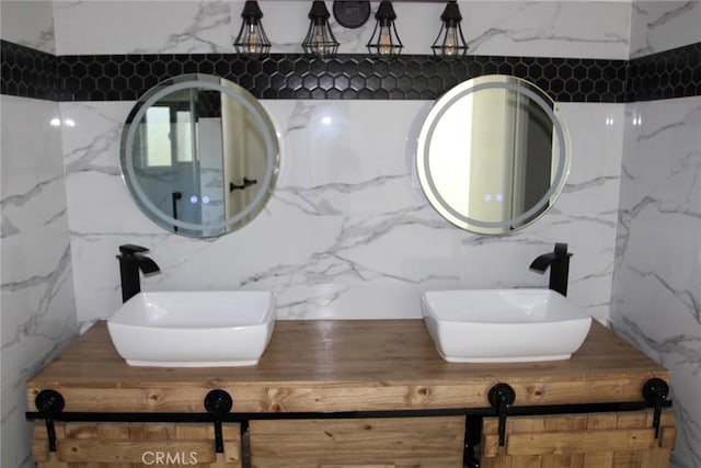 bathroom featuring vanity and tile walls