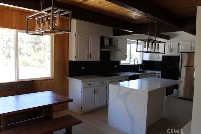 kitchen with white cabinetry, a kitchen island, wood ceiling, and black appliances