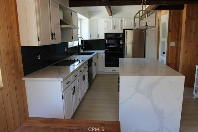 kitchen with white cabinetry, wall chimney exhaust hood, sink, and black appliances