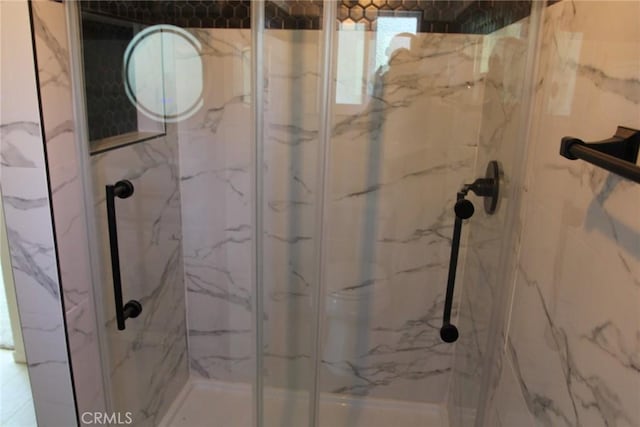 bathroom with a shower with shower door