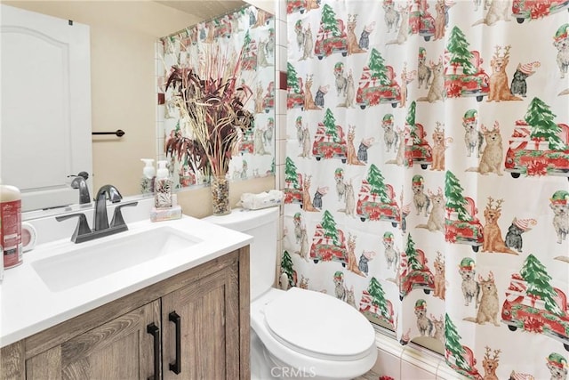 bathroom with vanity, toilet, and curtained shower