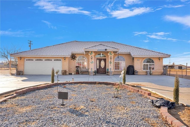 mediterranean / spanish house featuring a garage