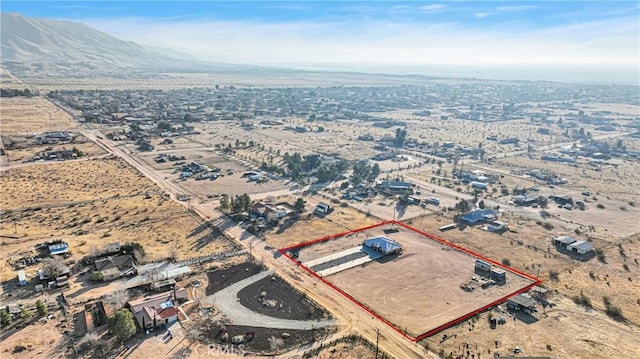 birds eye view of property with a mountain view