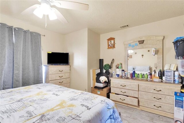 bedroom with ceiling fan and light wood-type flooring