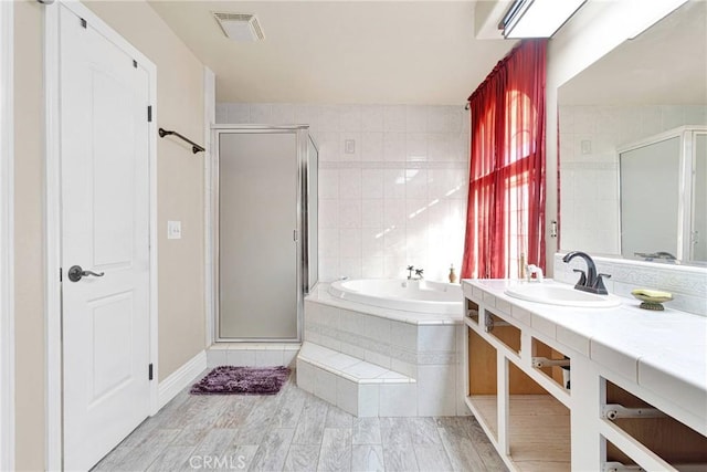 bathroom with vanity and plus walk in shower