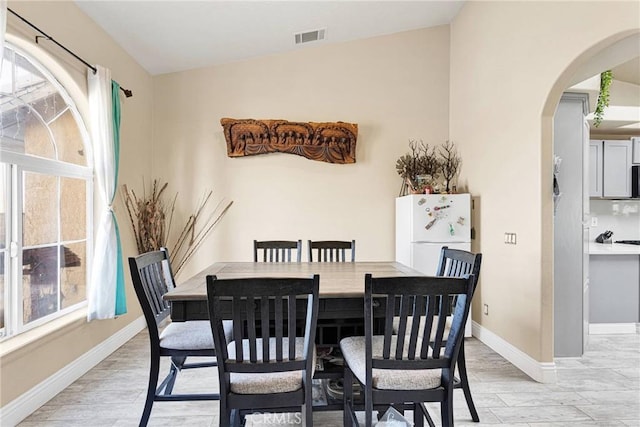 dining space with light hardwood / wood-style flooring