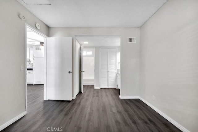 interior space with dark wood-type flooring and ceiling fan