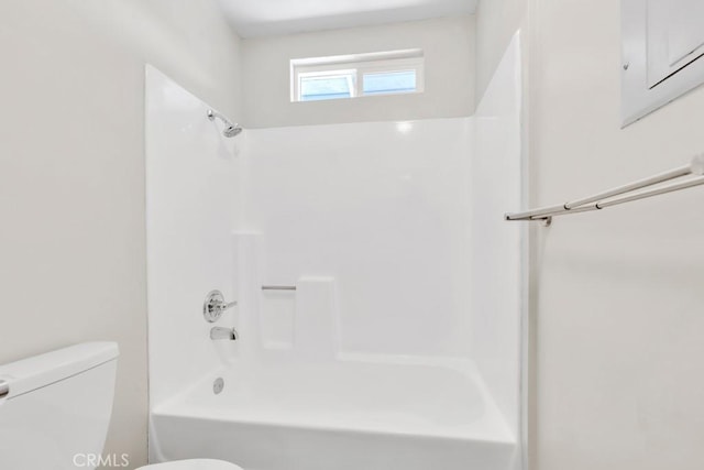 bathroom featuring toilet and bathing tub / shower combination