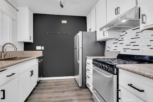 kitchen featuring dark hardwood / wood-style flooring, sink, white cabinets, and appliances with stainless steel finishes