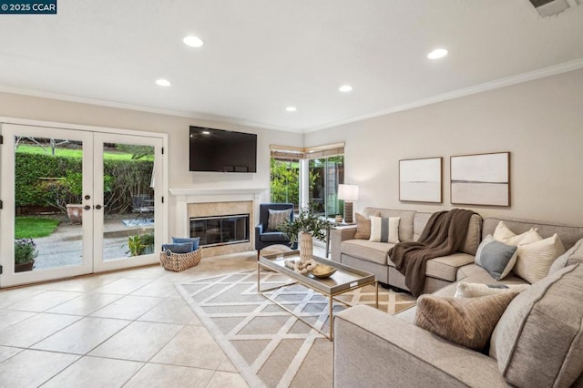 living room featuring french doors, ornamental molding, a fireplace, and light tile patterned floors