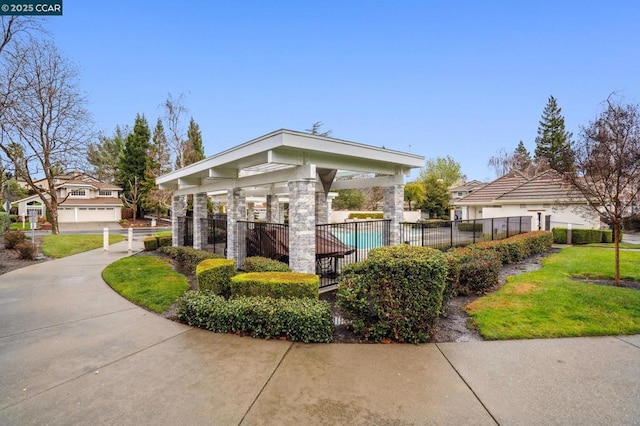 surrounding community featuring a pool and a lawn