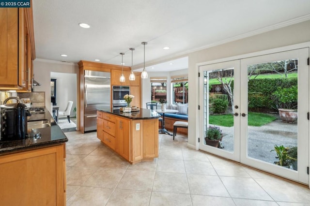 kitchen with french doors, hanging light fixtures, ornamental molding, appliances with stainless steel finishes, and a kitchen island