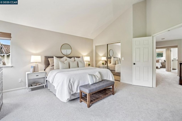 bedroom with light colored carpet, high vaulted ceiling, and a closet