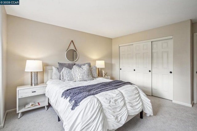 bedroom with light colored carpet and a closet