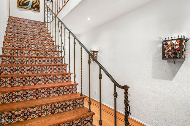 stairway with wood-type flooring