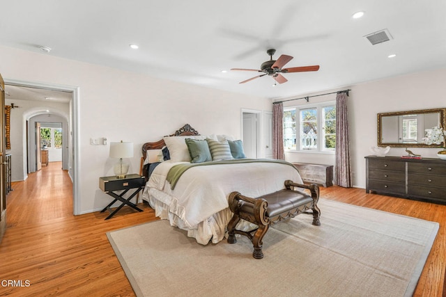 bedroom featuring multiple windows, ceiling fan, and light hardwood / wood-style floors