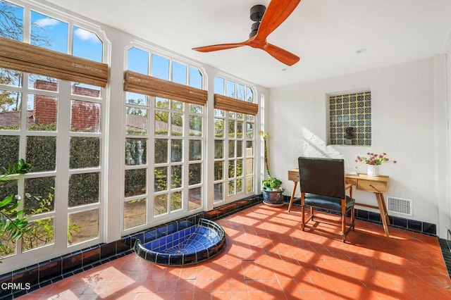 sunroom featuring ceiling fan