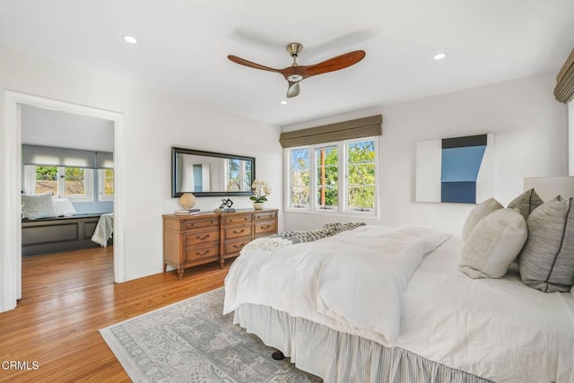 bedroom with light hardwood / wood-style flooring and ceiling fan