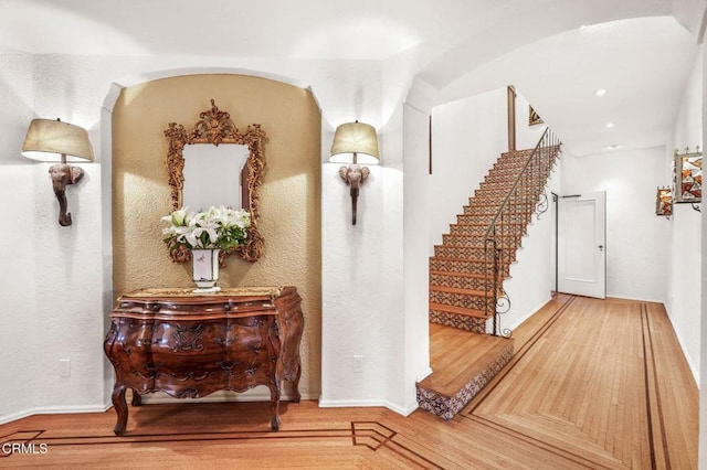 hallway with hardwood / wood-style floors